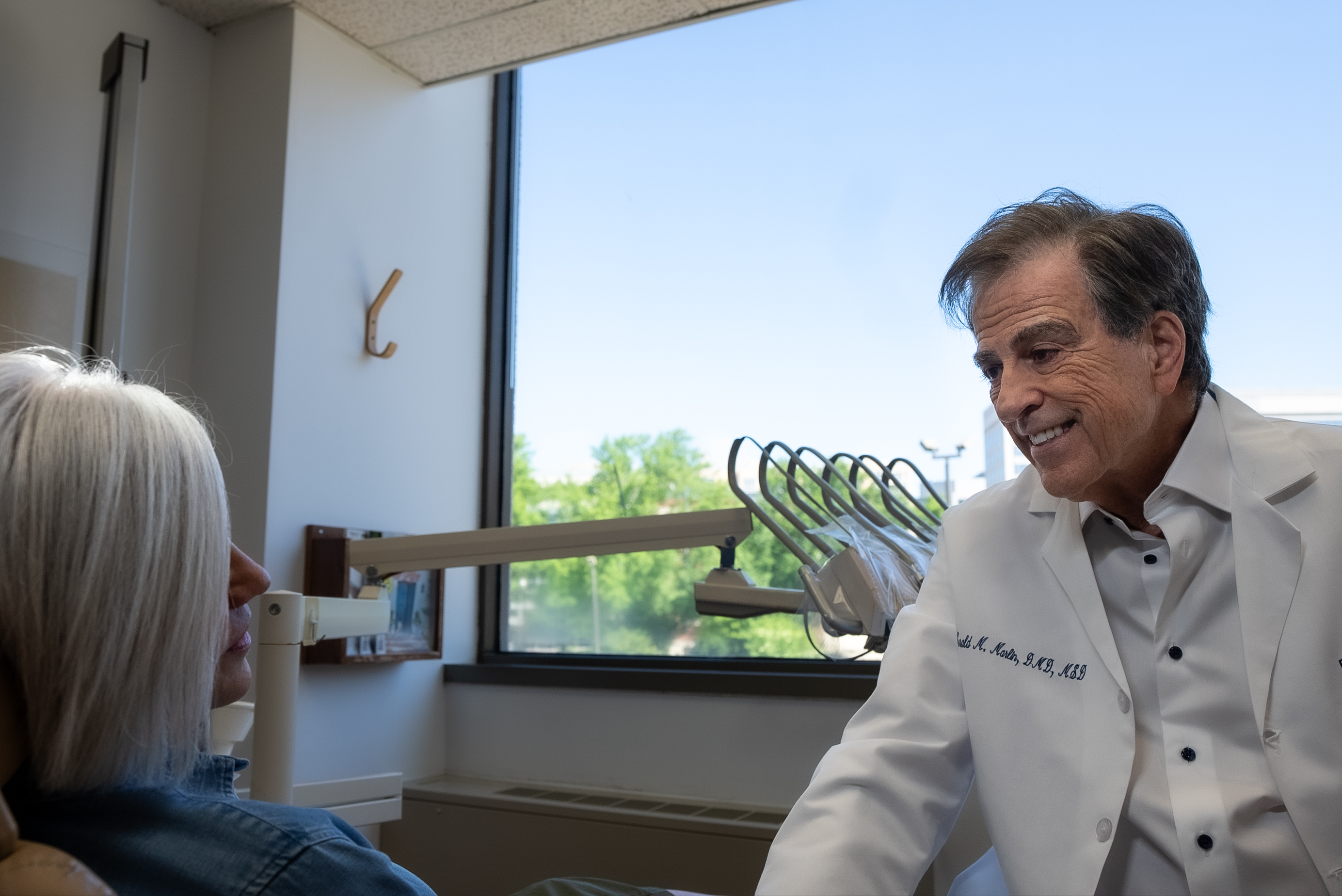 Specialist prosthodontist discussing single tooth implant procedure with Bethesda patient