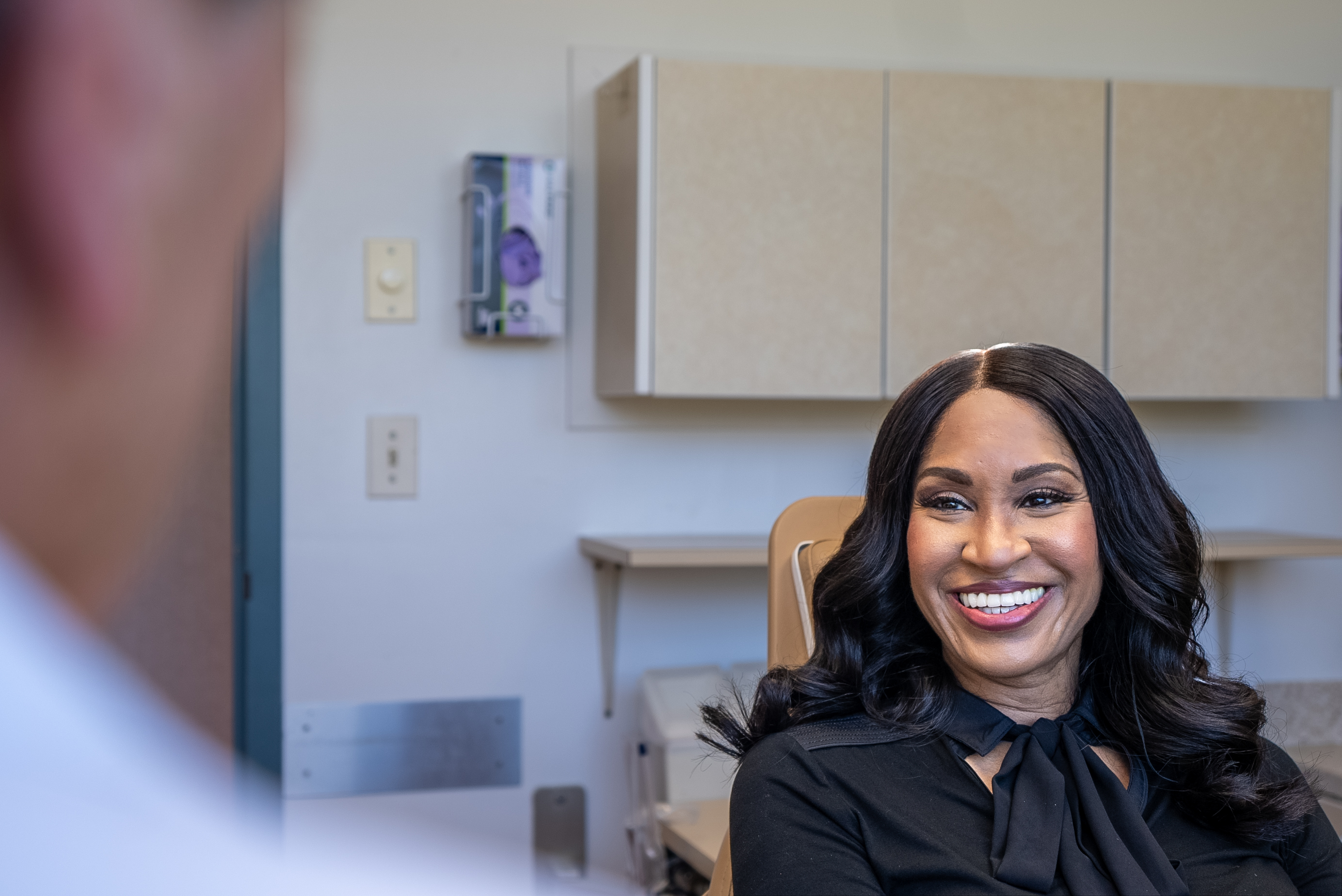 Patient discussing dental implant insurance coverage and financing options with the team at Elite Prosthetic Dentistry