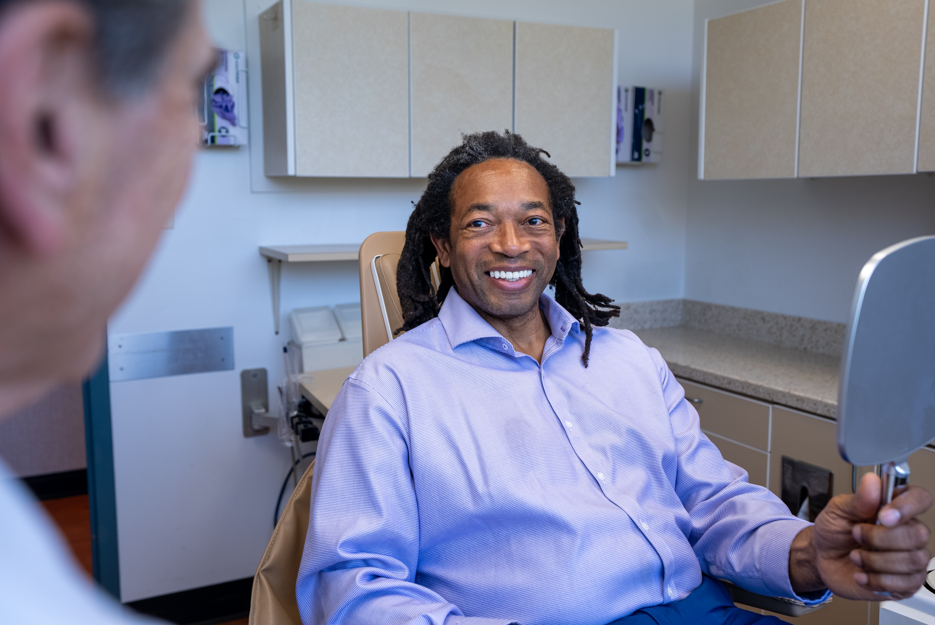 Post-operative dental implant recovery checkup with Dr. Marlin monitoring healing progress for Bethesda patient