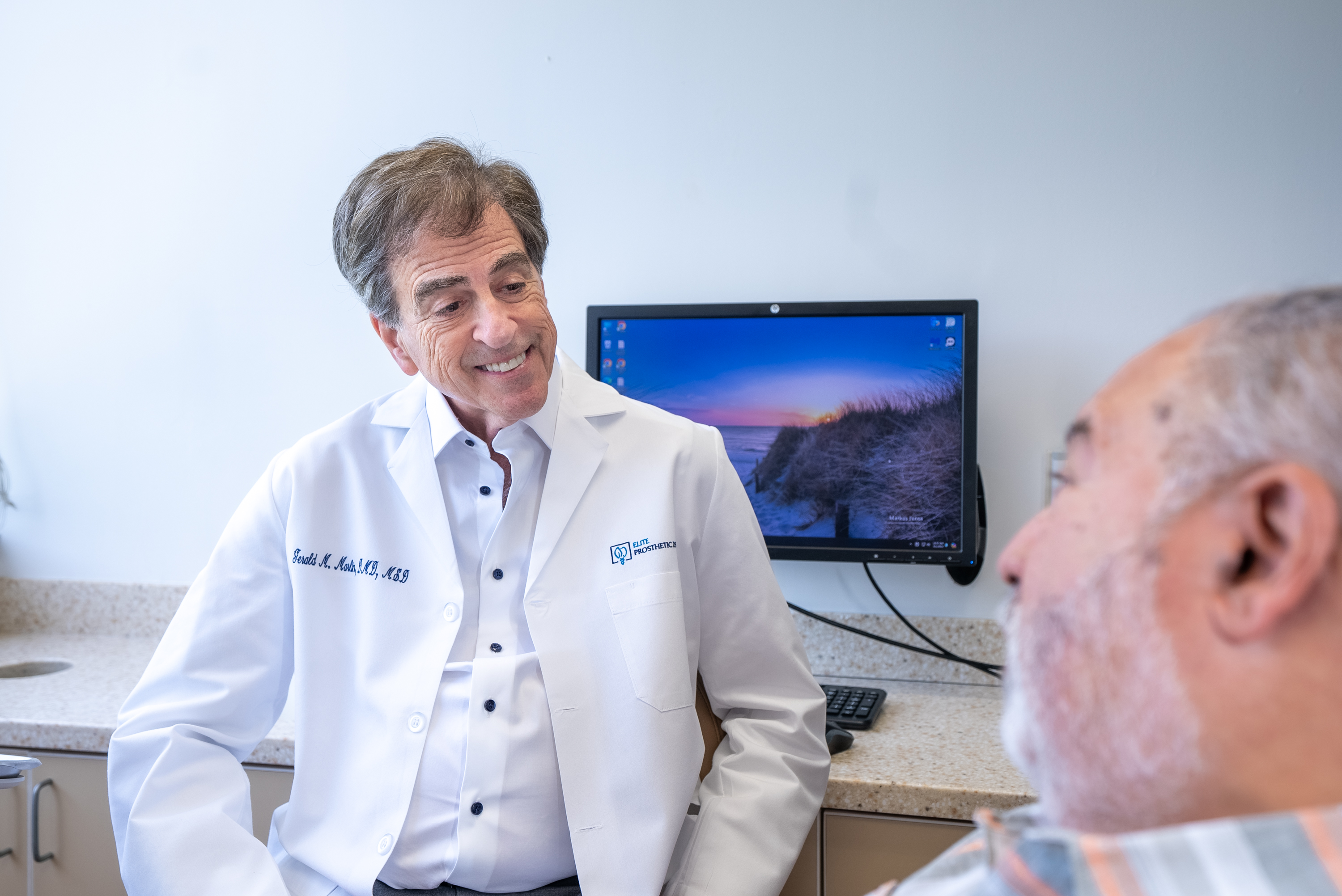 Patient with diabetes learning about dental implant options and special considerations during a consultation